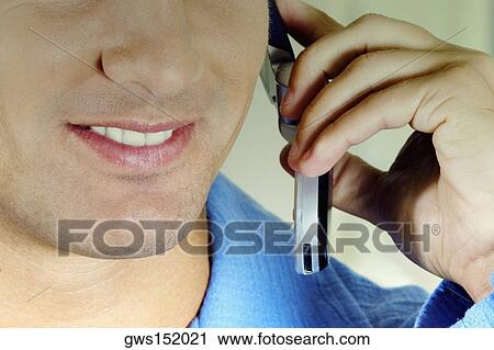 Close-up of a businessman talking on a mobile phone and smiling View Large Photo Image Stock Image - Close-up of a businessman talking on a mobile phone and smiling. Fotosearch