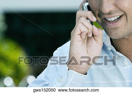 Close-up of a businessman talking on a mobile phone View Large Photo Image Stock Image - Close-up of a businessman talking on a mobile phone. Fotosearch