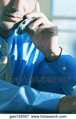 Close-up of a businessman talking on a mobile phone View Large Photo Image Stock Photo - Close-up of a businessman talking on a mobile phone. Fotosearch