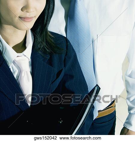 Close-up of a businesswoman and a businessman standing together View Large Photo Image Stock Image - Close-up of a businesswoman and a businessman standing together. Fotosearch