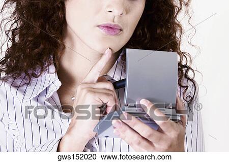 Close-up of a businesswoman holding a pen with a calculator and thinking View Large Photo Image Stock Image - Close-up of a businesswoman holding a pen with a calculator and thinking. Fotosearch