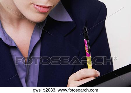 Close-up of a businesswoman holding a pen and thinking View Large Photo Image Stock Image - Close-up of a businesswoman holding a pen and thinking. Fotosearch
