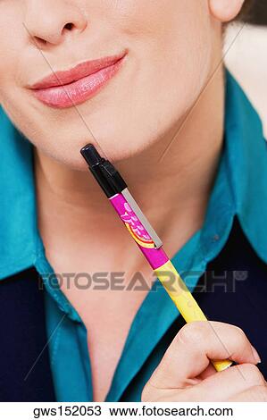 Close-up of a businesswoman holding a pen and thinking View Large Photo Image Stock Image - Close-up of a businesswoman holding a pen and thinking. Fotosearch