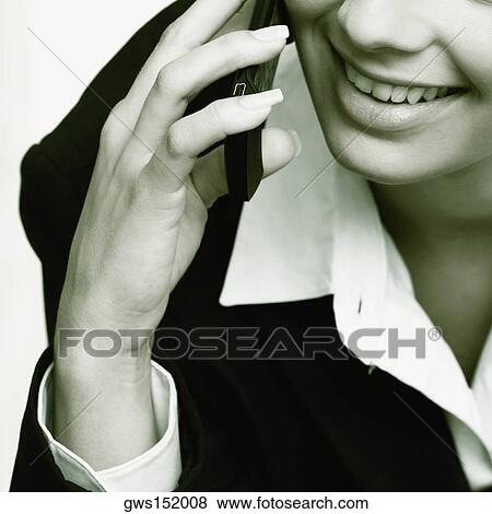 Close-up of a businesswoman talking on a mobile phone and smiling View Large Photo Image Stock Photo - Close-up of a businesswoman talking on a mobile phone and smiling. Fotosearch