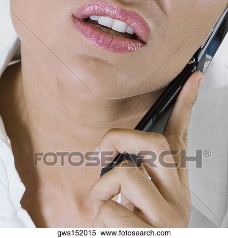 Stock Photography - Close-up of a businesswoman talking on a mobile phone. Fotosearch