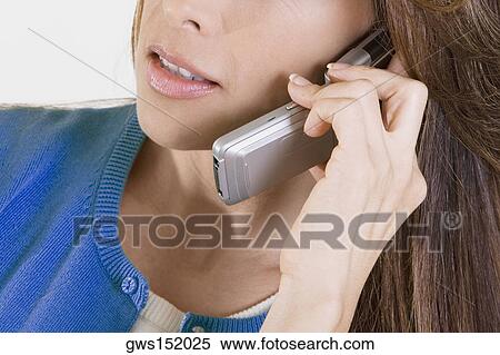 Close-up of a businesswoman talking on a mobile phone View Large Photo Image Stock Photography - Close-up of a businesswoman talking on a mobile phone. Fotosearch