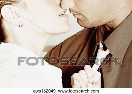 Close-up of a young couple kissing each other View Large Photo Image Stock Photo - Close-up of a young couple kissing each other. Fotosearch
