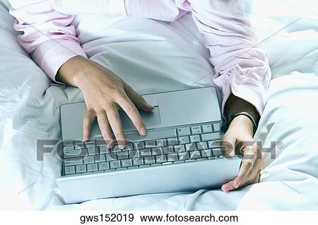 Stock Photo - High angle view of a businessman using a laptop. Fotosearch
