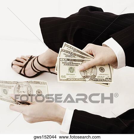 High angle view of a businesswoman holding dollar bills View Large Photo Image Picture - High angle view of a businesswoman holding dollar bills. Fotosearch
