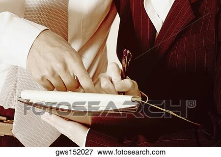 Mid section view of a businessman and a businesswoman discussing View Large Photo Image Stock Photo - Mid section view of a businessman and a businesswoman discussing. Fotosearch