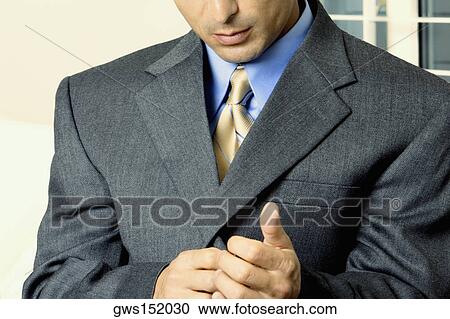 Mid section view of a businessman buttoning his suit View Large Photo Image Stock Image - Mid section view of a businessman buttoning his suit. Fotosearch
