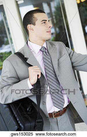 Close-up of a businessman carrying a bag View Large Photo Image Stock Photography - Close-up of a businessman carrying a bag. Fotosearch