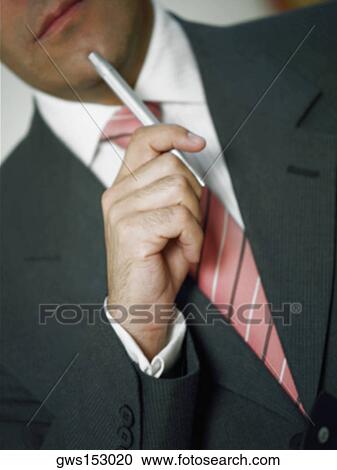 Close-up of a businessman holding a pen View Large Photo Image Stock Image - Close-up of a businessman holding a pen. Fotosearch