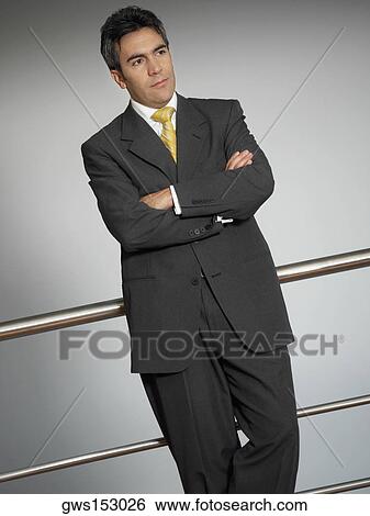 Close-up of a businessman leaning against a railing View Large Photo Image Stock Photograph - Close-up of a businessman leaning against a railing. Fotosearch
