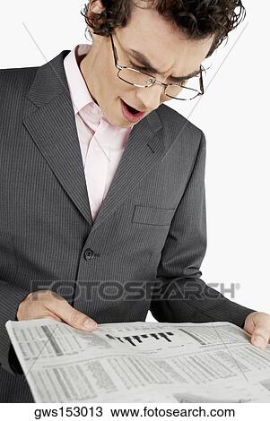 Close-up of a businessman reading a newspaper View Large Photo Image Stock Image - Close-up of a businessman reading a newspaper. Fotosearch