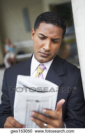 Close-up of a businessman reading a newspaper View Large Photo Image Stock Image - Close-up of a businessman reading a newspaper. Fotosearch