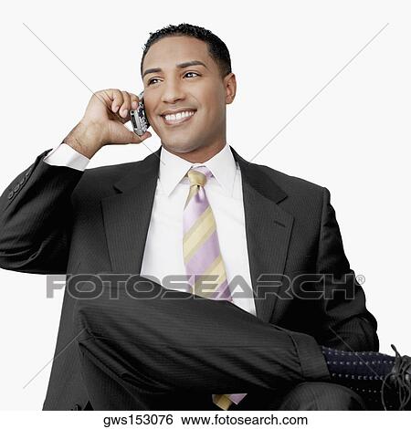 Close-up of a businessman talking on a mobile phone View Large Photo Image Stock Photograph - Close-up of a businessman talking on a mobile phone. Fotosearch