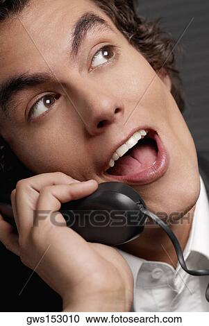 Stock Image - Close-up of a businessman talking on the telephone. Fotosearch
