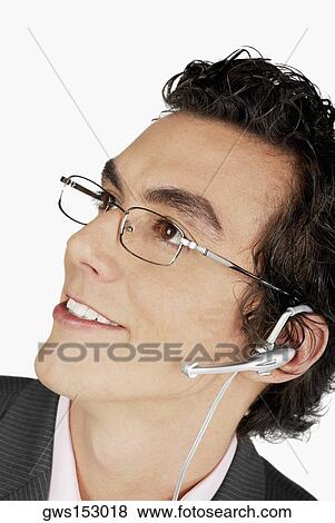 Close-up of a businessman wearing a hands free device View Large Photo Image Stock Photo - Close-up of a businessman wearing a hands free device. Fotosearch