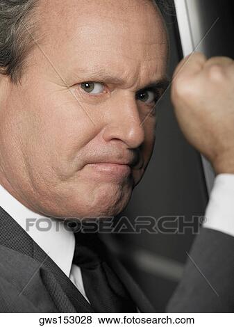 Stock Photo - Portrait of a businessman looking furious. Fotosearch