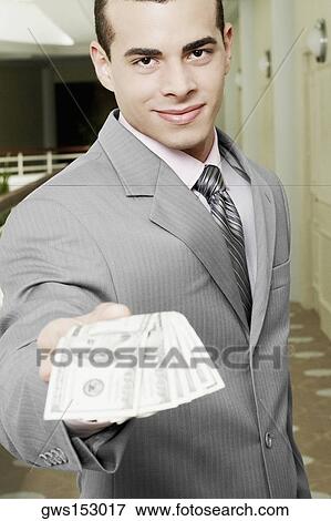 Portrait of a businessman showing American paper currency View Large Photo Image Stock Photo - Portrait of a businessman showing American paper currency. Fotosearch