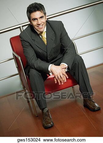 Portrait of a businessman sitting in an armchair View Large Photo Image Picture - Portrait of a businessman sitting in an armchair. Fotosearch
