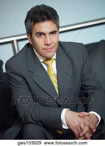 Portrait of a businessman sitting on a couch and smiling View Large Photo Image Stock Photo - Portrait of a businessman sitting on a couch and smiling. Fotosearch