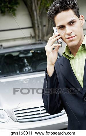 Stock Image - Portrait of a businessman talking on a mobile phone. Fotosearch