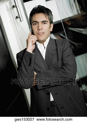Portrait of a businessman talking on a mobile phone View Large Photo Image Stock Photo - Portrait of a businessman talking on a mobile phone. Fotosearch