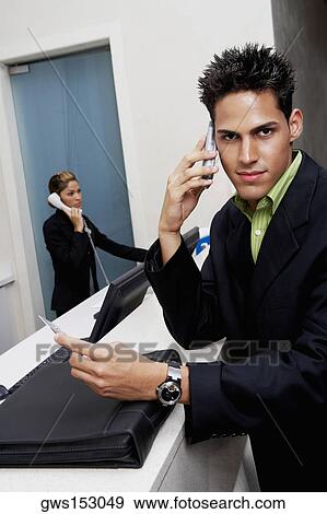 Portrait of a businessman using a mobile phone View Large Photo Image Stock Photo - Portrait of a businessman using a mobile phone. Fotosearch