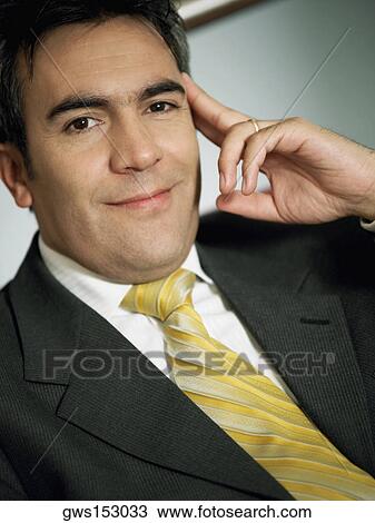 Stock Image - Portrait of a businessman with his head in his hands. Fotosearch