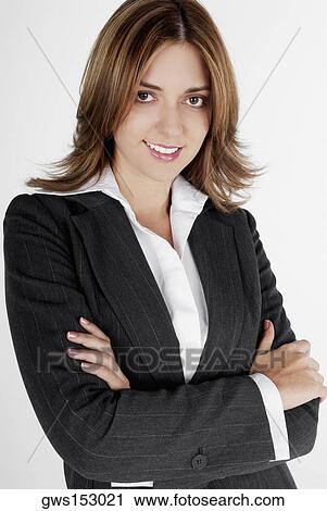 Portrait of a businesswoman smiling with her arms folded View Large Photo Image Stock Image - Portrait of a businesswoman smiling with her arms folded. Fotosearch