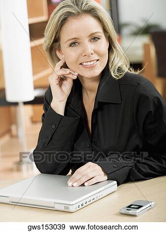 Stock Photo - Portrait of a mid adult woman smiling. Fotosearch