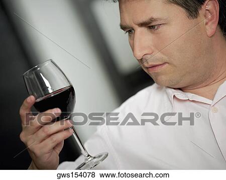 Close-up of a mature man holding a glass of wine View Large Photo Image Stock Photo - Close-up of a mature man holding a glass of wine. Fotosearch
