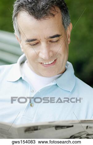 Close-up of a mid adult man reading a newspaper View Large Photo Image Stock Image - Close-up of a mid adult man reading a newspaper. Fotosearch