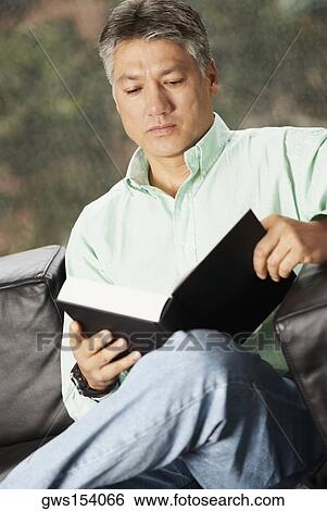 Close-up of a senior man reading a book View Large Photo Image Stock Photograph - Close-up of a senior man reading a book. Fotosearch