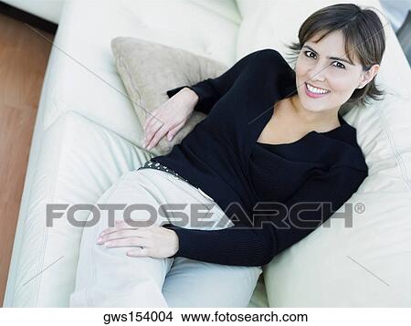Portrait of a businesswoman reclining on a couch View Large Photo Image Picture - Portrait of a businesswoman reclining on a couch. Fotosearch