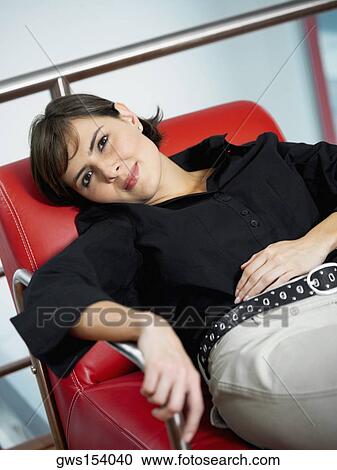 Portrait of a businesswoman reclining in an armchair View Large Photo Image Stock Image - Portrait of a businesswoman reclining in an armchair. Fotosearch