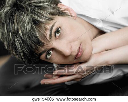 Portrait of a mature woman lying on her side View Large Photo Image Stock Photography - Portrait of a mature woman lying on her side. Fotosearch