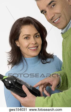 Stock Image - Portrait of a mid adult couple smiling. Fotosearch