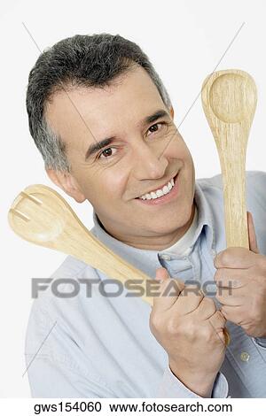 Portrait of a mid adult man holding salad servers View Large Photo Image Stock Image - Portrait of a mid adult man holding salad servers. Fotosearch