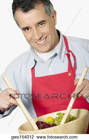 Portrait of a mid adult man tossing salad with ladles View Large Photo Image Stock Image - Portrait of a mid adult man tossing salad with ladles. Fotosearch