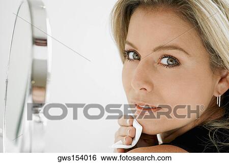 Portrait of a mid adult woman applying face powder View Large Photo Image Stock Photograph - Portrait of a mid adult woman applying face powder. Fotosearch