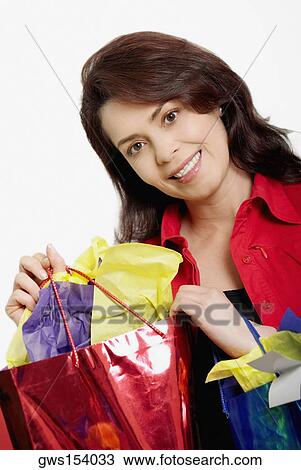 Portrait of a mid adult woman holding a shopping bag View Large Photo Image Stock Image - Portrait of a mid adult woman holding a shopping bag. Fotosearch
