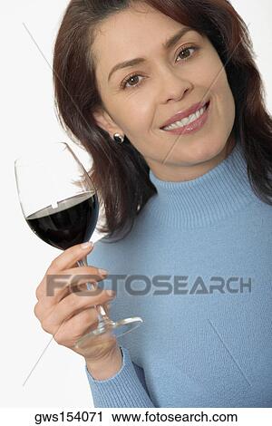 Portrait of a mid adult woman holding a glass of red wine View Large Photo Image Stock Image - Portrait of a mid adult woman holding a glass of red wine. Fotosearch