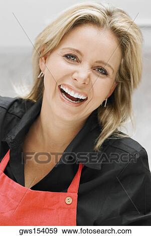 Stock Photo - Portrait of a mid adult woman laughing. Fotosearch