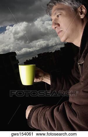 Side profile of a senior man holding a coffee mug and thinking View Large Photo Image Stock Image - Side profile of a senior man holding a coffee mug and thinking. Fotosearch