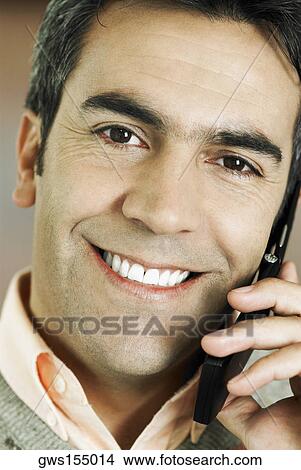 Portrait of a mature man talking on a mobile phone View Large Photo Image Picture - Portrait of a mature man talking on a mobile phone. Fotosearch