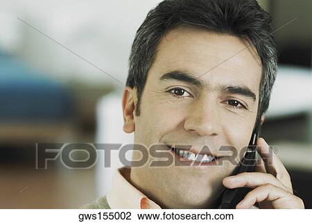 Stock Image - Portrait of a mature man talking on a mobile phone. Fotosearch