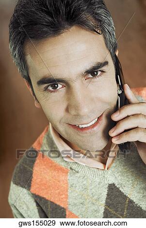 Portrait of a mature man talking on a mobile phone View Large Photo Image Stock Photo - Portrait of a mature man talking on a mobile phone. Fotosearch